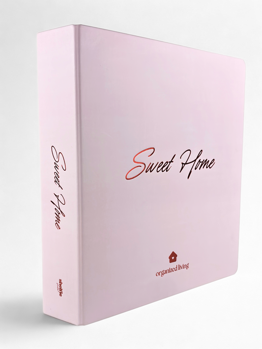 Pink notebook with 'Sweet Home' and 'organized living' text on a white background