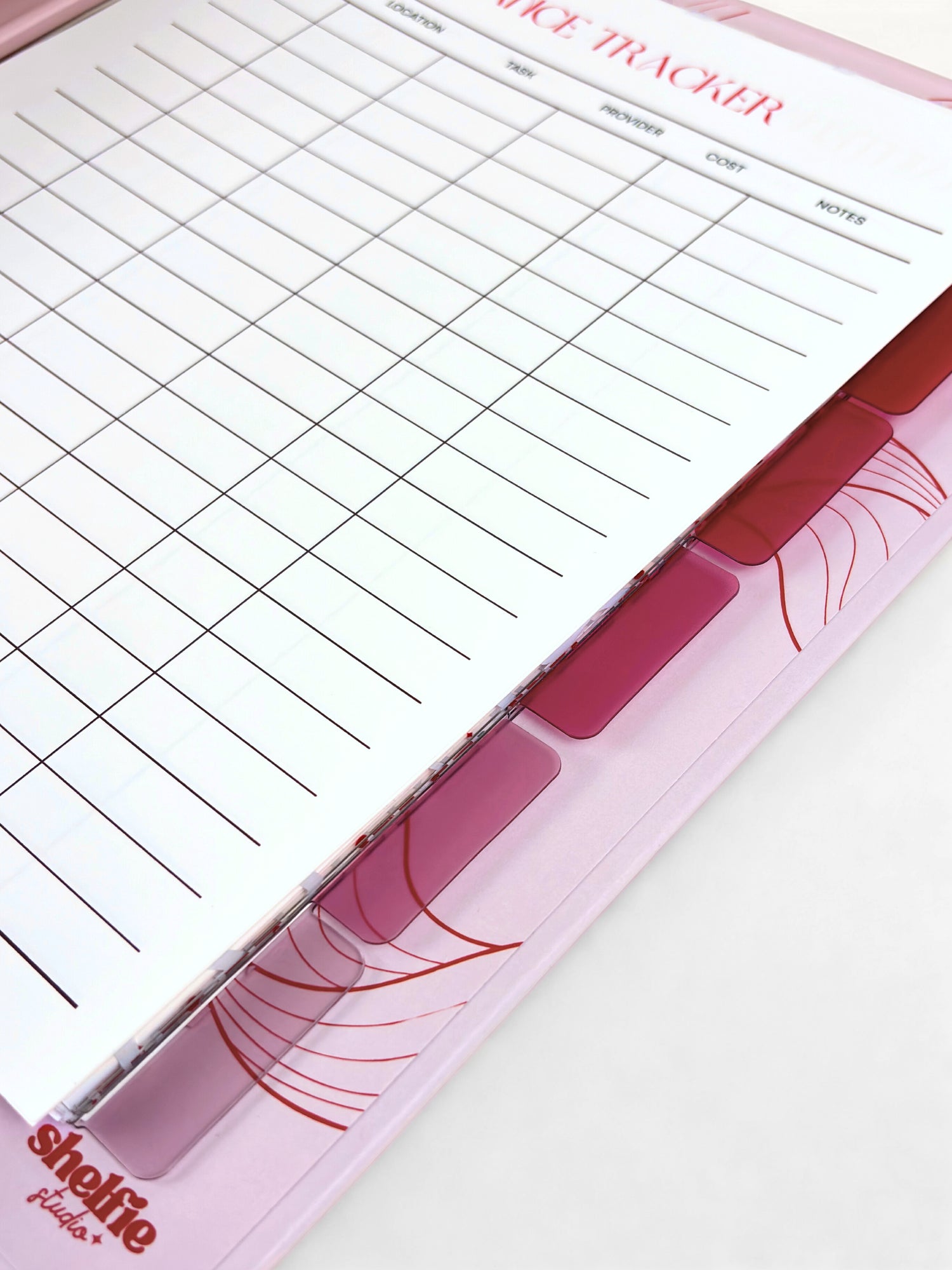 Pink and white dice tracker with grid layout on a white background