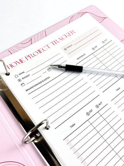 Home project tracker with a pen on a pink surface